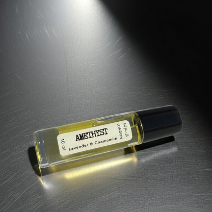 Amethyst perfume bottle with lavender and chamomile scent on a metallic surface