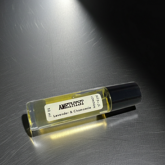 Amethyst perfume bottle with lavender and chamomile scent on a metallic surface