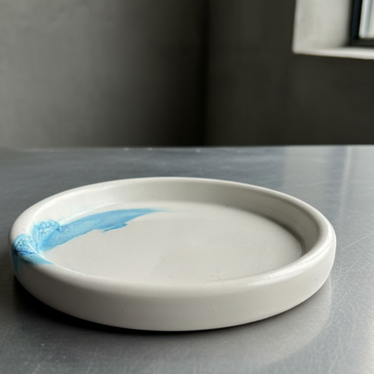 Ceramic dish with blue accent on a gray surface