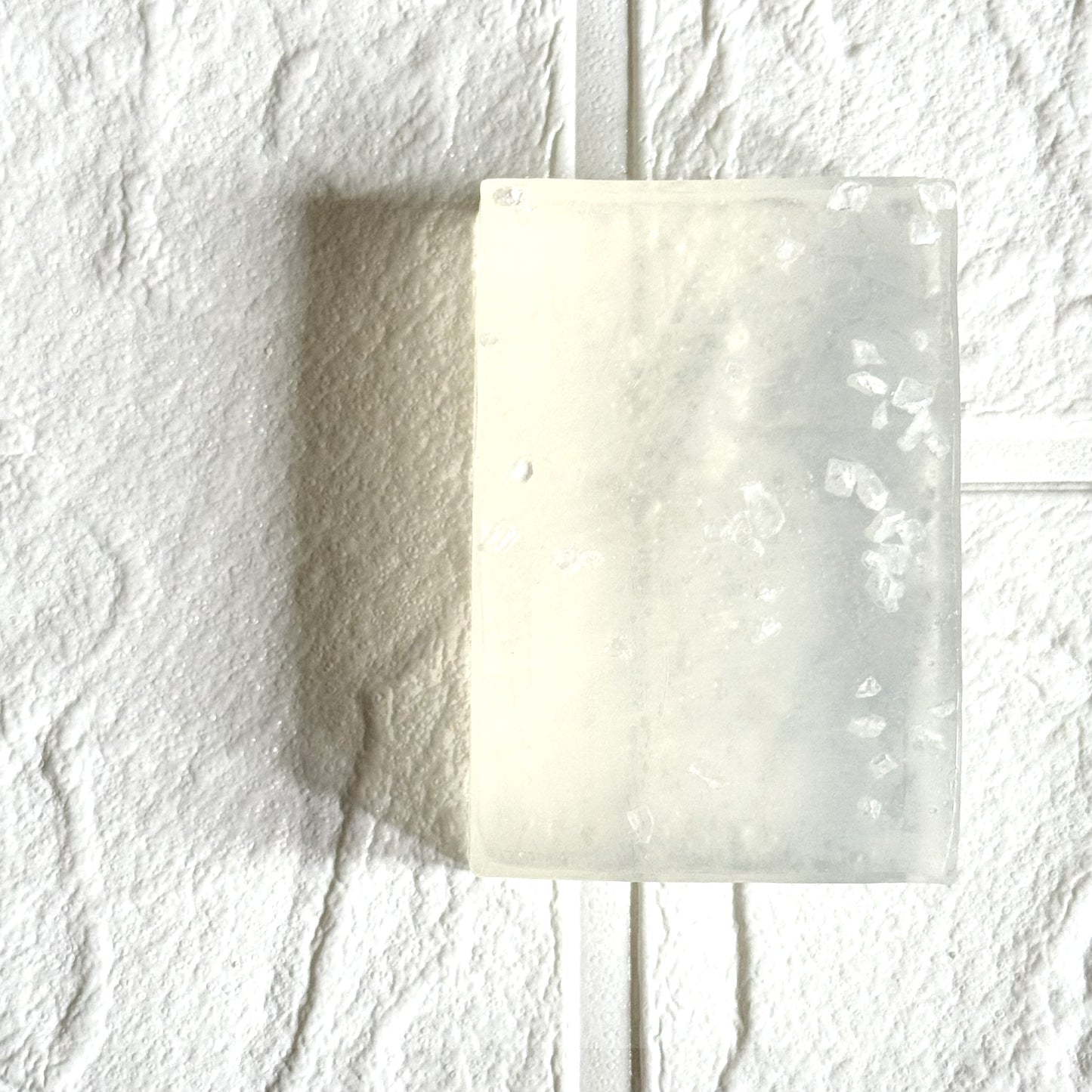 Transparent glycerine soap on a textured white background