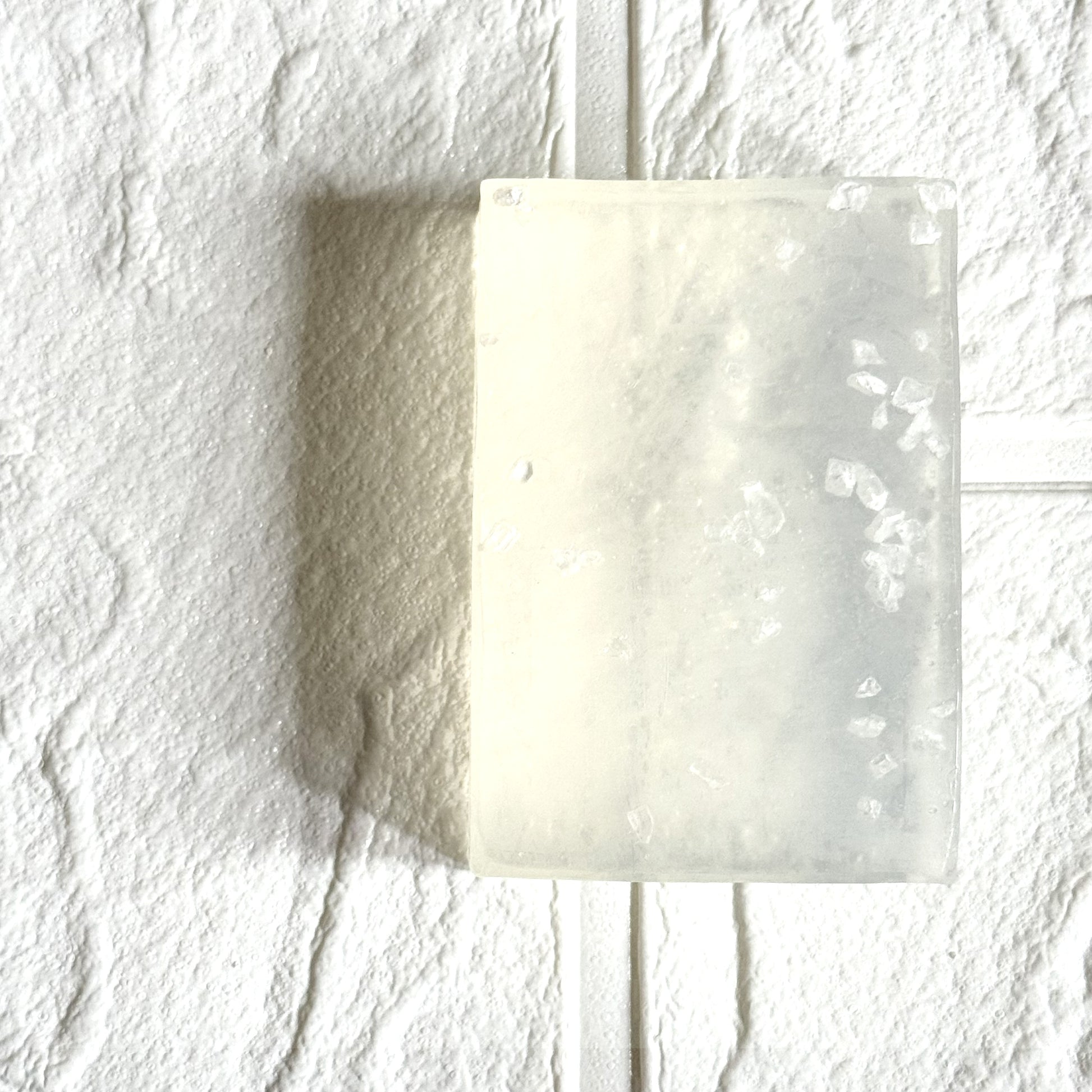 Transparent glycerine soap on a textured white background