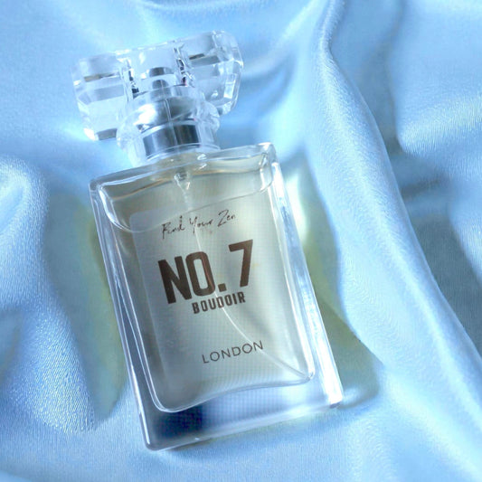 Perfume bottle labeled 'No. 7' on a white fabric background